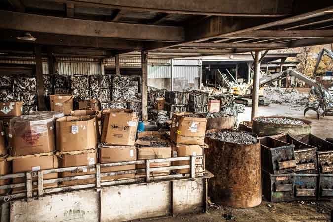 Boxed scrap materials stored under warehouse roof